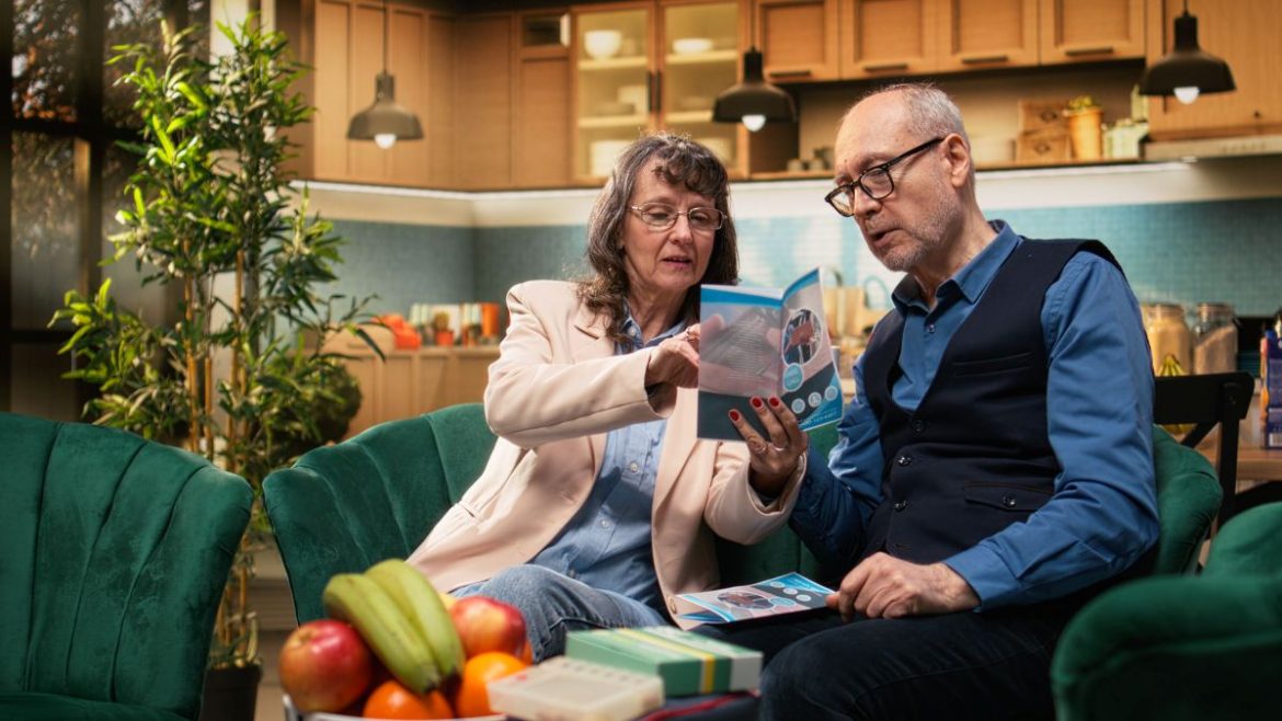elderly couple looking at a clinical trial brochure